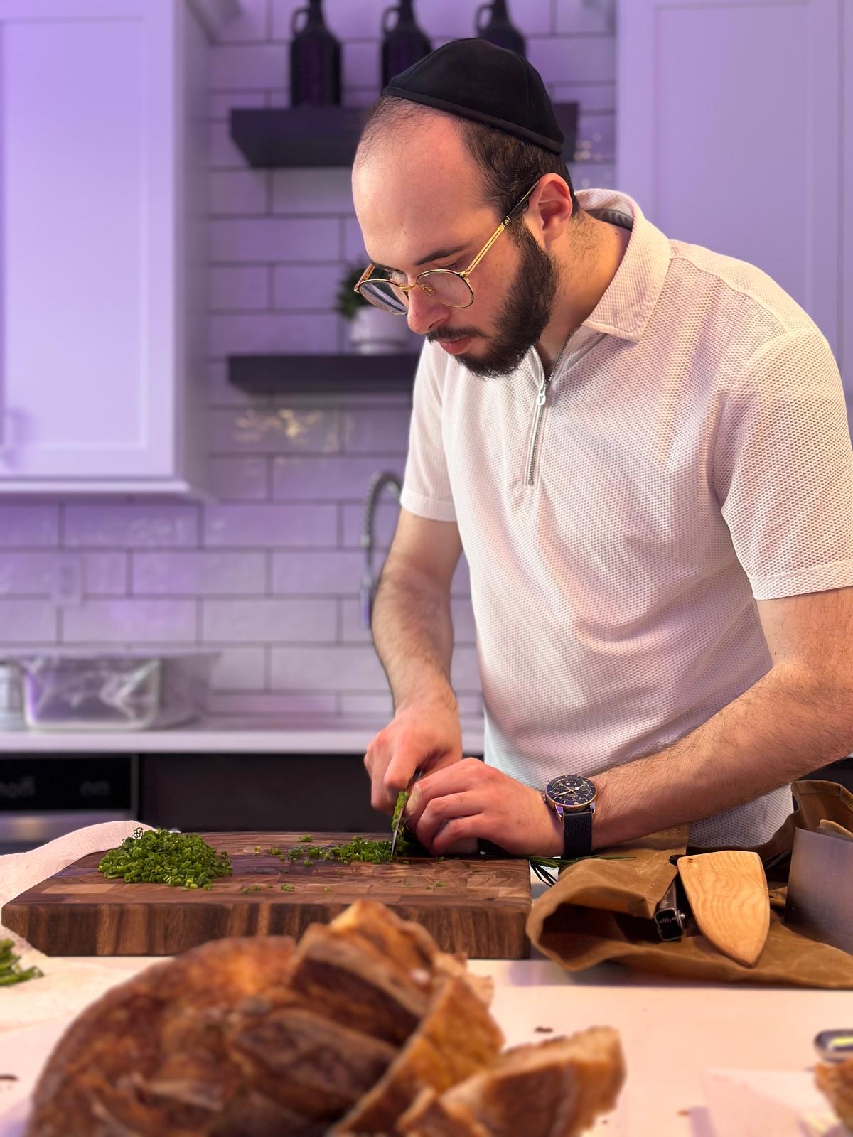 Chef Shayala chopping herbs at a kitchen worktop