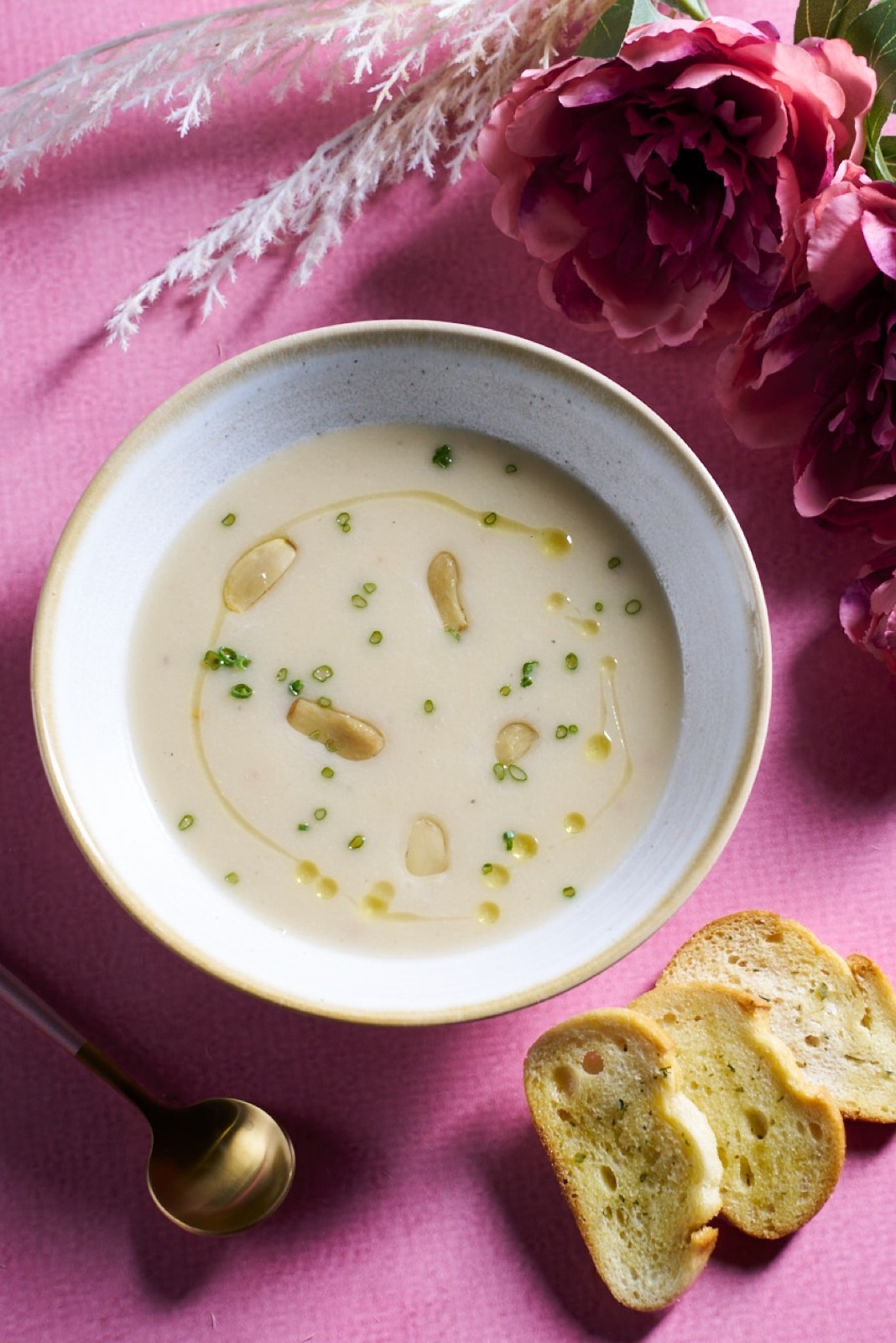 Creamy soup with garlic, herbs, and toast