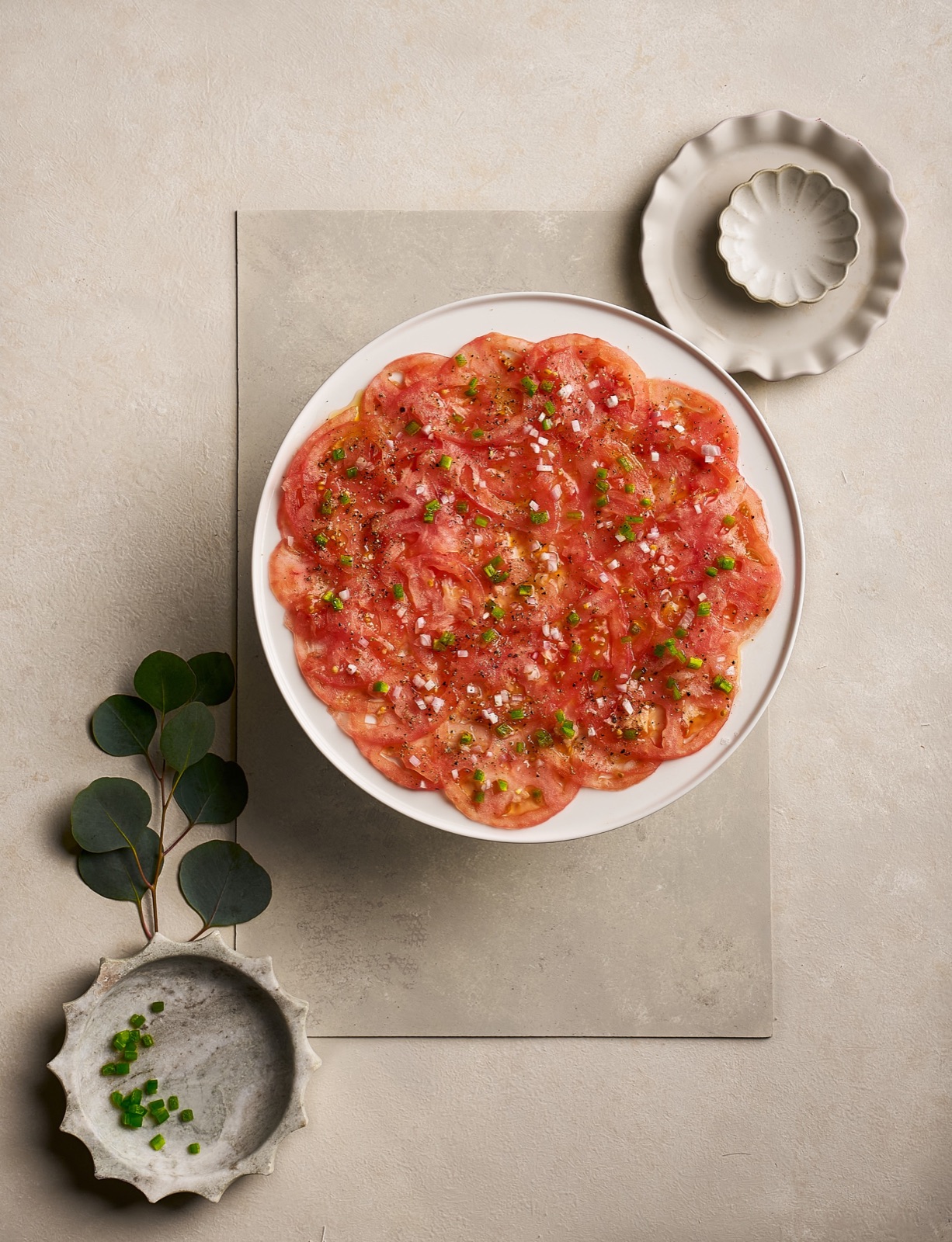 Tomato carpaccio arranged in a circle for an editorial photograph